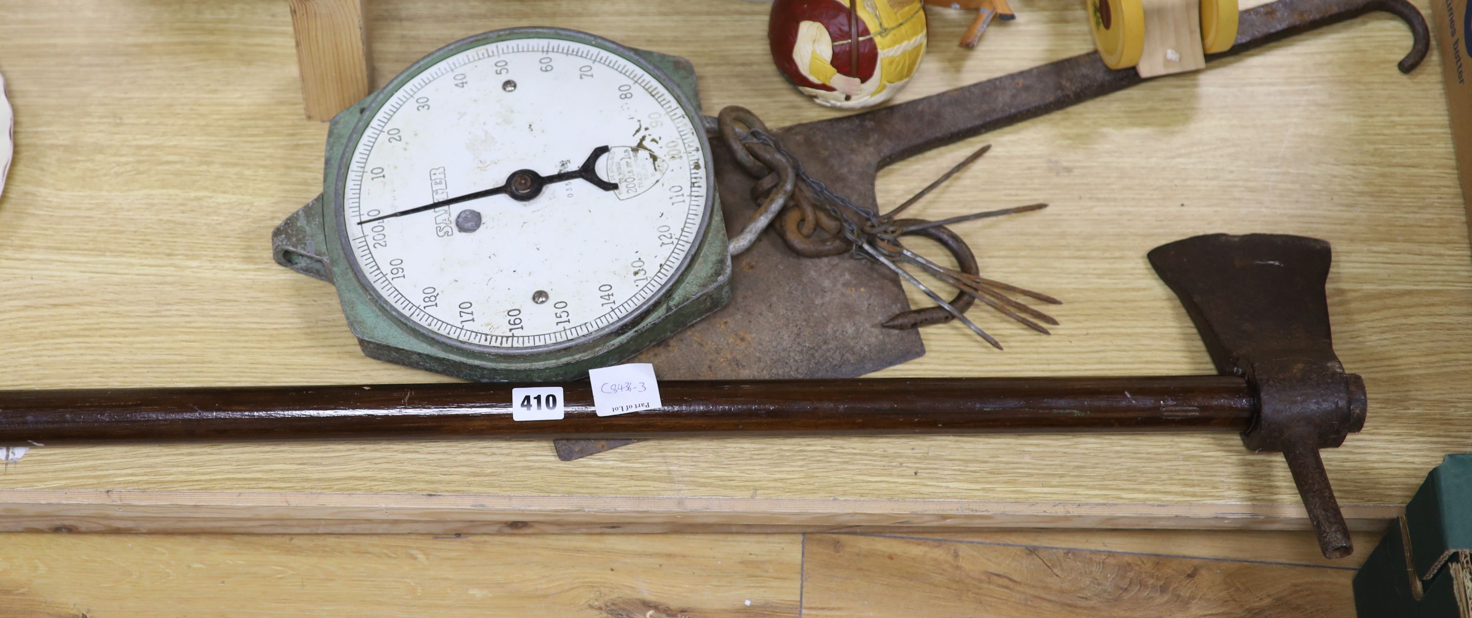 Items from an abbatoir; a twin head axe, iron chopper, a set of Salter scales and a meat skewer